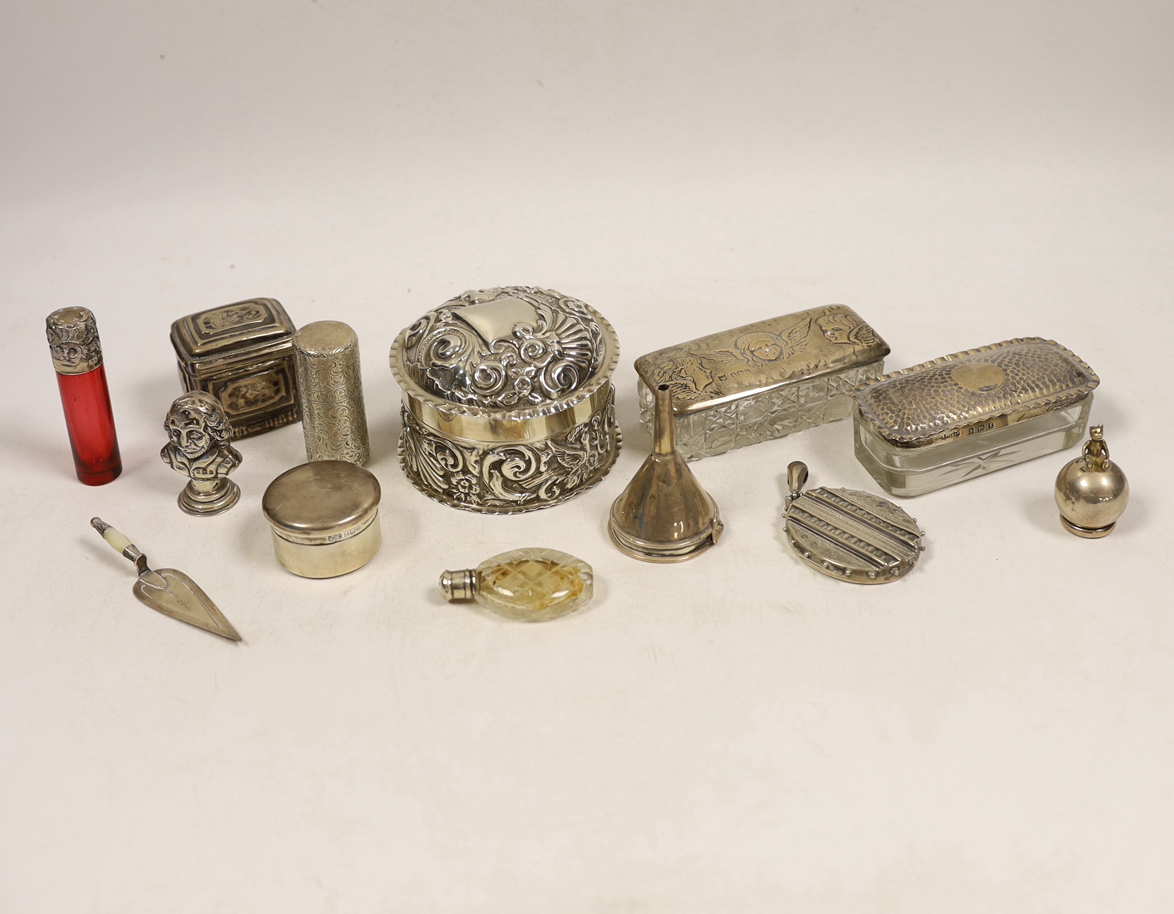 Small silver including two silver mounted glass toilet boxes, a Victorian engraved scent bottle by Sampson Mordan, a perfume funnel, Edwardian Shakespeare bust seal, repousse box and cover, locket, bookmark, etc.